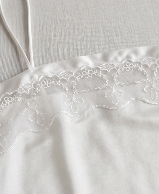 Close-up of Hush camisole floral embroidery and slender strap