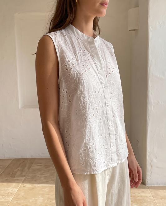 Dawn white embroidered shirt folded on a wooden table