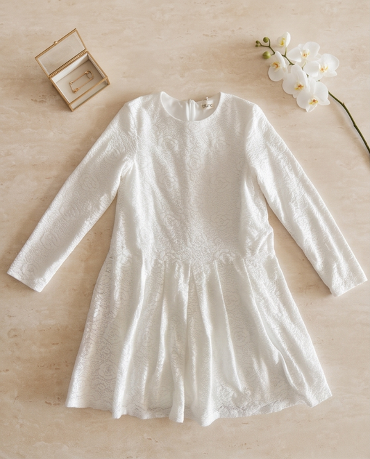 Dusk white long-sleeved dress with a flared skirt, worn in warm natural light